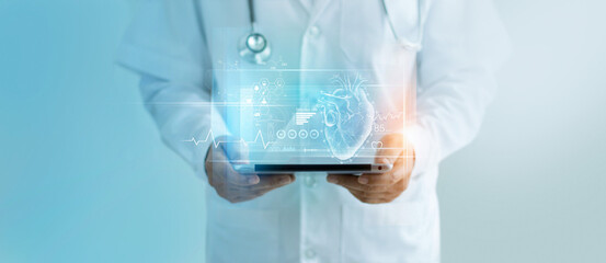 Cardiologist doctor holding tablet and analysis result heart of patient virtual on modern hologram...