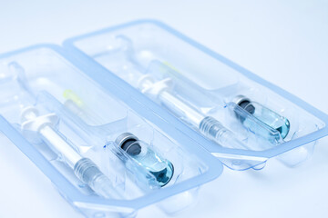 Covid-19, flu, coronavirus liquid vaccine vial bottle and syringe set in plastic package container...