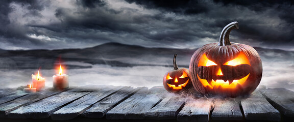 Halloween Pumpkin On Table In A Fog Landscape