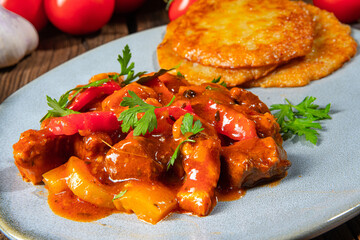 Original Hungarian goulash with potato pancakes
