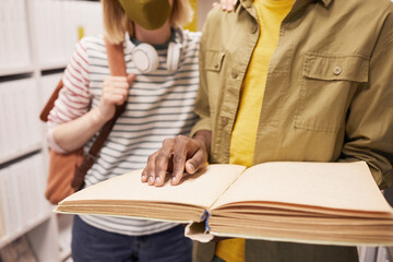 Cropped portrait of student helping blind friend in library, copy space