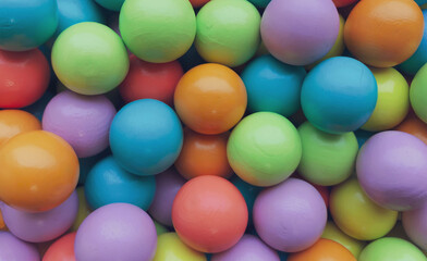 Fototapeta na wymiar Background from multicolored bright small wooden balls of blue, yellow, red, lilac and green colors