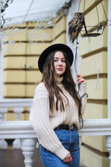 young beautiful girl in a sweater and hat with an owl.