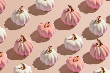 Flat lay pattern from white and pink decorative autumn pumpkins on beige background in hard light. - 451375967