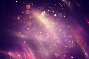 background of abstract gold, pink, purple and black glitter lights. defocused