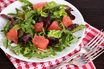 Grapefruit salad, a mix of lettuce, arugula and olive dressing. Dietary menu. Proper nutrition. Vegetarian food.