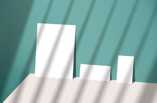 Blank paper sheet card with copy space and sunlight shadow on blue background. for mock-up creative design template.