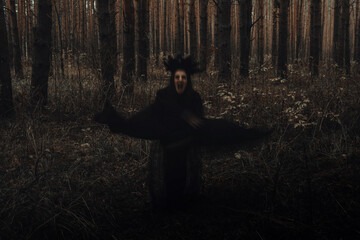 blurry frightening black silhouette of an evil witch