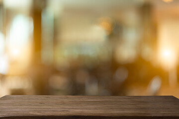 Abstract bokeh sunlight background with wood table.	
