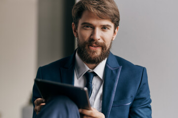 Cheerful business man tablet in hands communicating work