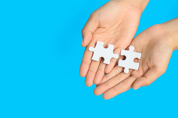 jigsaw puzzle in hand on blue background