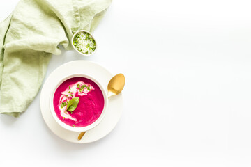 Beet cream soup made of fresh beetroots with sour cream and basil