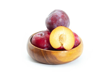 Fresh plum in wooden bowl on background, Healthy food.