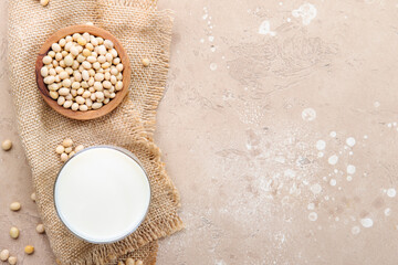 Vegan Soy milk and soy bean on beige table. Vegan drink. Negative space