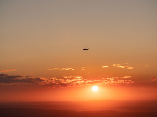 Fototapeta na wymiar A plane flies through the sunset. Hochtaunus Feldberg 