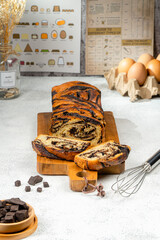 Chocolate Babka or Brioche Bread is prepared with a yeast-leavened dough that is rolled out and spread with a filling such as chocolate, fruit, or cheese, then rolled up and braided before baking.