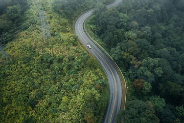 Fototapeta premium Mountain road in rainy and foggy day