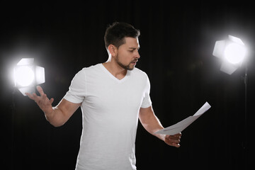 Professional actor reading his script during rehearsal in theatre - obrazy, fototapety, plakaty