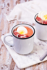 Spanish salmorejo cream soup with ham and egg