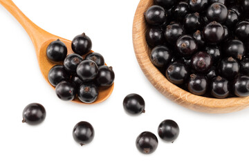 black currant in wooden bowl isolated on white background. macro. clipping path