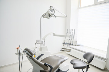 Dentist's office interior with modern chair and special dentisd equipment. Dentist office. Dentist chair in high class dental clinic. Dentist office. Medical concept.