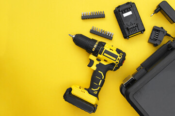 The yellow-black screwdriver on a yellow background, a set of bits.