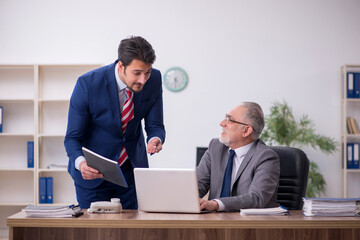 Two male employees working in the office