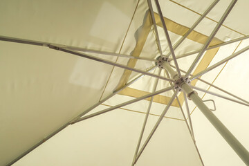 sand-colored parasol from the inside as a background