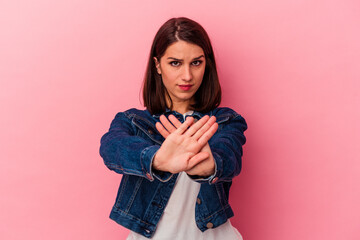 Young caucasian woman isolated on pink background doing a denial gesture