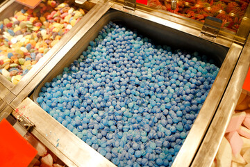 Different lollipops in candy shop. Sweet bonbons with different flavours.