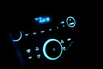 Automobile stereo in neon light at night. Dashboard with audio equipment in cabin of the modern new car - obrazy, fototapety, plakaty