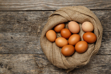Ecological farm chicken eggs on a rustic wooden table.