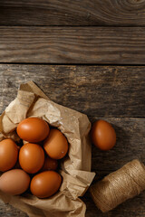 Ecological farm chicken eggs on a rustic wooden table.