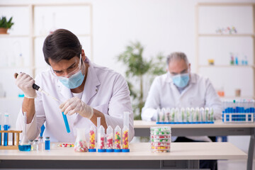 Two male chemists in drugs synthesis concept at the lab