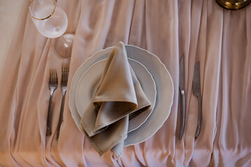 Luxurious wedding table decoration for reception of guests with stylish napkins. Wedding restaurant decoration
