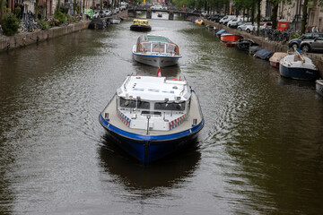 Police Boat And Canal Cruise Boats At Amsterdam The Netherlands 16-8-2021