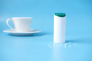artificial sweetener container on blue background 