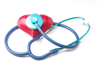 Obraz na płótnie Canvas Stethoscope with a red heart shape on a white table, health care concept
