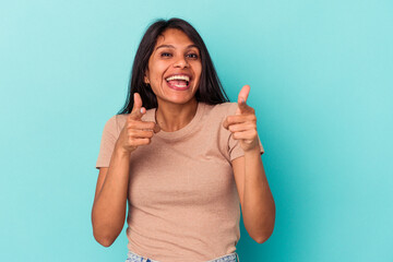 Young latin woman isolated on blue background cheerful smiles pointing to front.