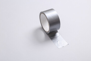 Roll of scotch tape on gray background. Minimalism.