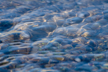 Natural soft background from running water. The surface of the river. Specially defocused photo. Copy space.