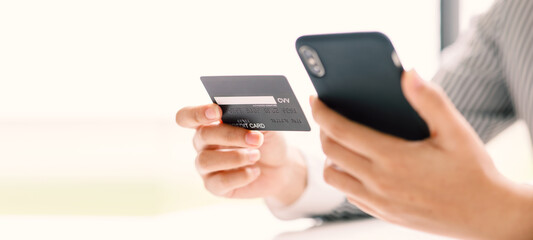 Woman hands using smartphone for online shopping and credit card at home, Payment Detail page display and credit card, online shopping concepts