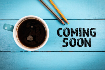 Coming Soon. Coffee mug and pencils on office desk