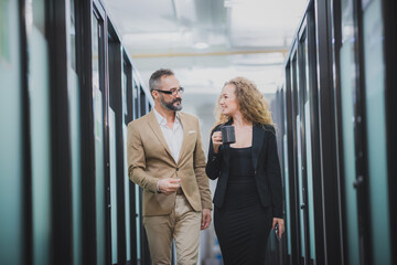 beautiful women walking on the aisle and take a sip of her coffee mug, modern office lifrstyle...