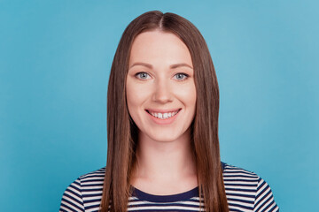 Fototapeta premium Portrait of lovely adorable positive lady toothy beaming smile on blue background