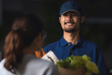 close up portrait of deliverman, smiling guy in blue t-shirt uniform, online shopping grocery...