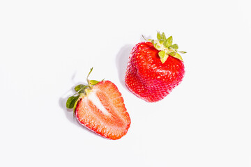 Whole and half ripe strawberry isolated on white background