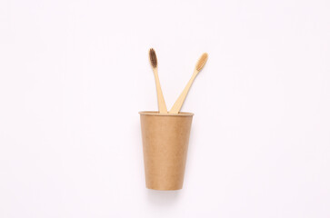 Plastic free toothbrushes in a cup. Zero waste, eco friendly concept. Flat lay.