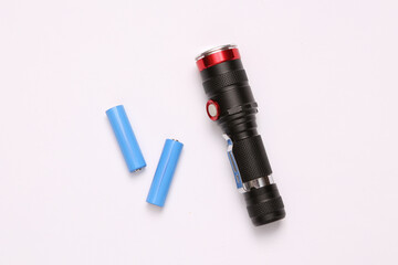 Flashlight with batteries on a white background