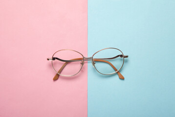 Optical eye glasses on pink blue background